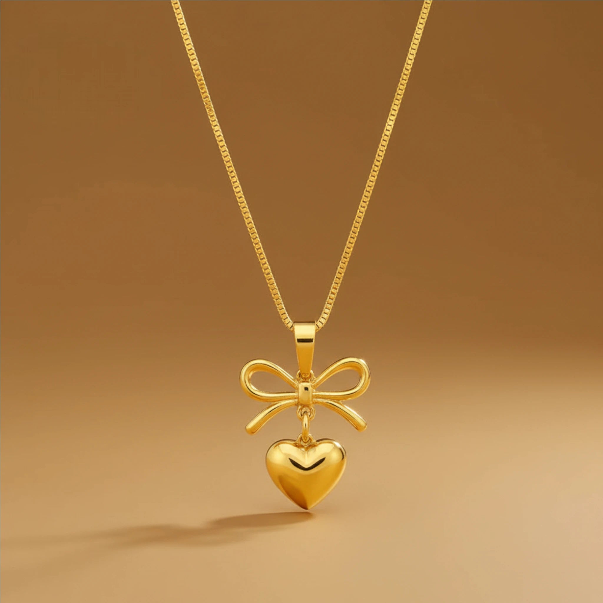 Gold Heart Necklace with Bow Pendant